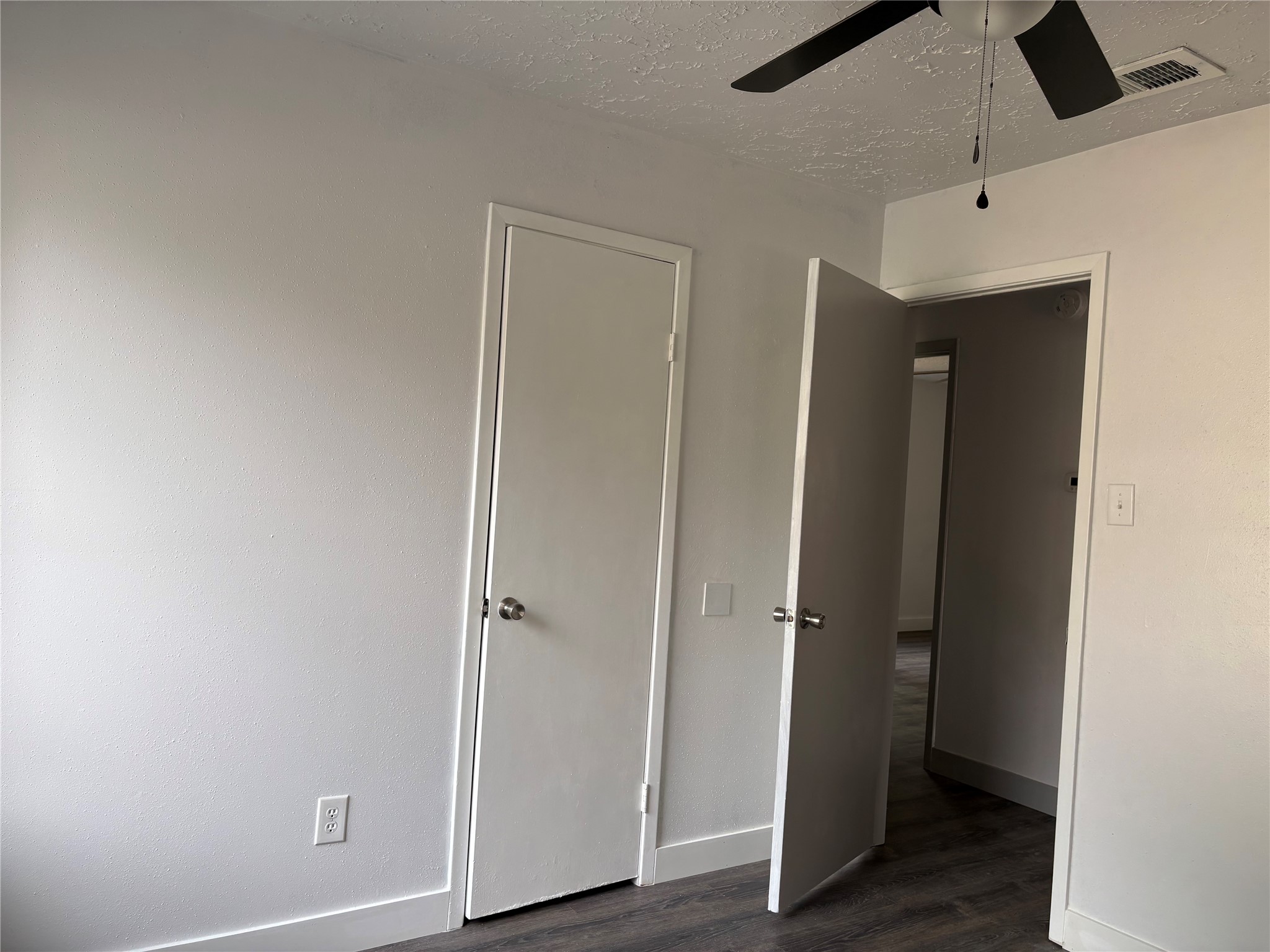 4631 Enchanted Rock Lane Spring, TX 77388 - Photo 9 of 10 Unfurnished bedroom featuring dark wood-type flooring, a textured ceiling, and ceiling fan