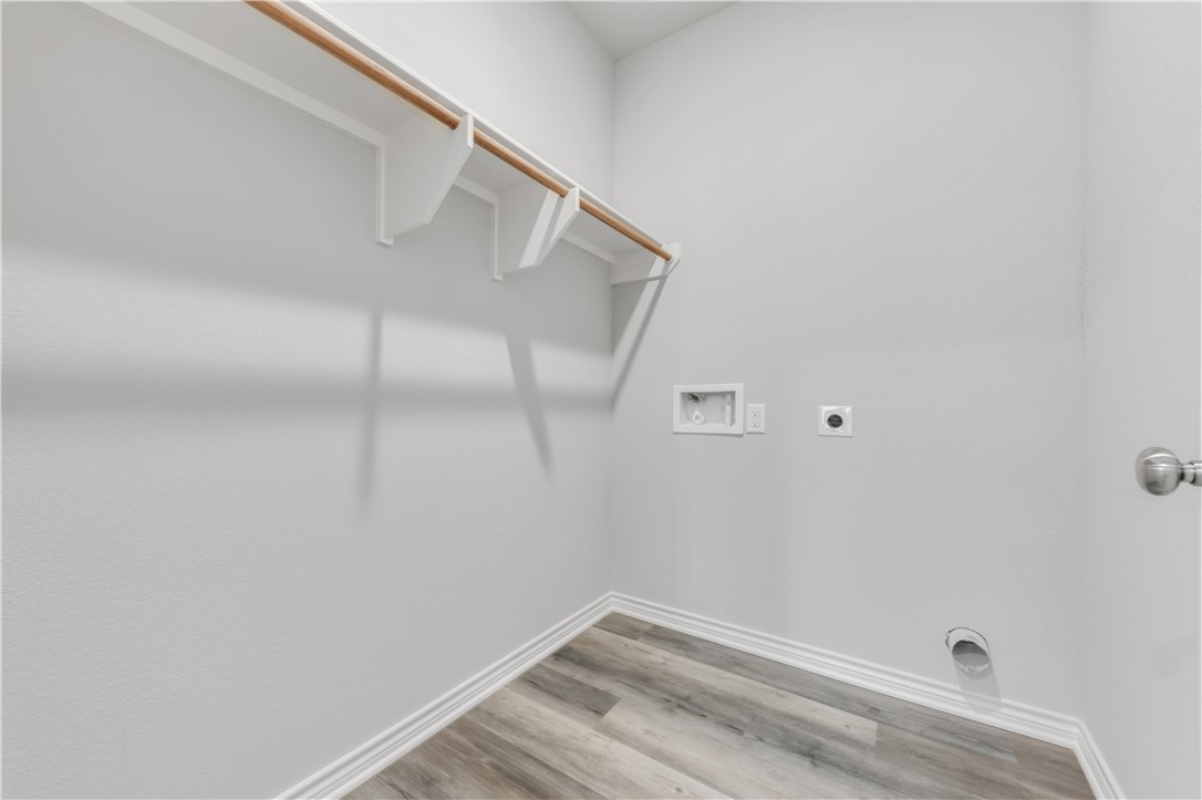 1805 Pin Oak Street Bryan, TX 77803 - Photo 18 of 20 Laundry room with hookup for a washing machine, electric dryer hookup, and light wood finished floors