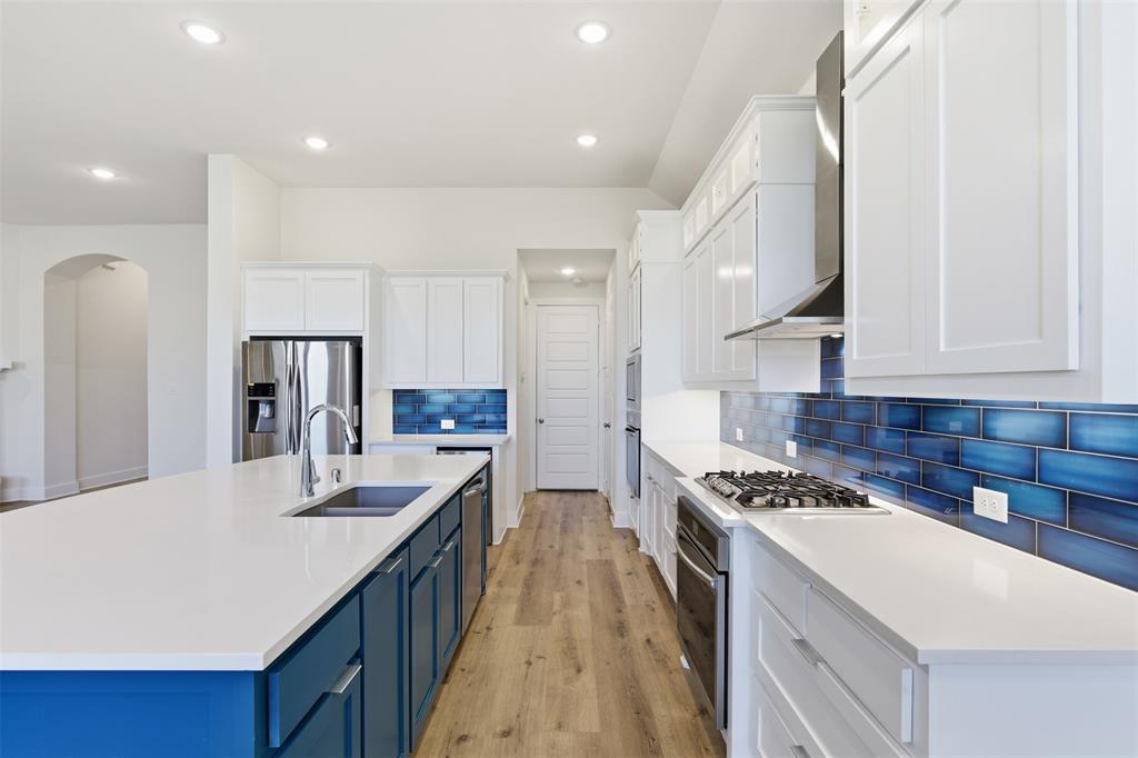 4400 Rocky Rdg Trail Little Elm, TX 75068 - Photo 17 of 40 a kitchen with a sink stove and refrigerator