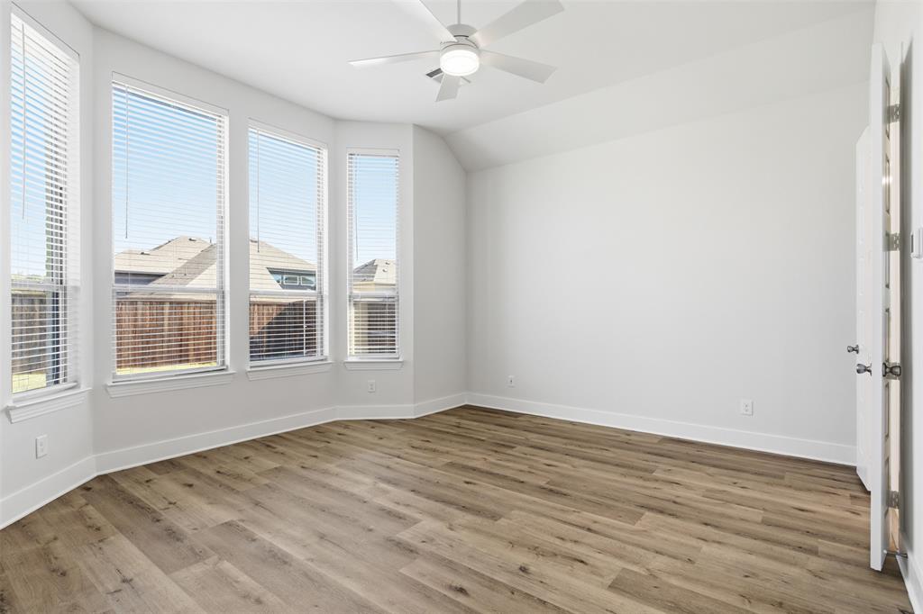 4400 Rocky Rdg Trail Little Elm, TX 75068 - Photo 19 of 40 an empty room with wooden floor and windows