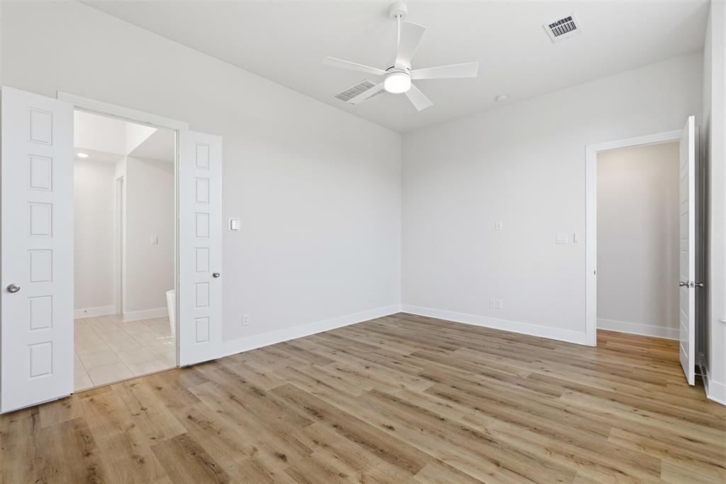 4400 Rocky Rdg Trail Little Elm, TX 75068 - Photo 21 of 40 Unfurnished primary bedroom with light wood-style flooring and ceiling fan
