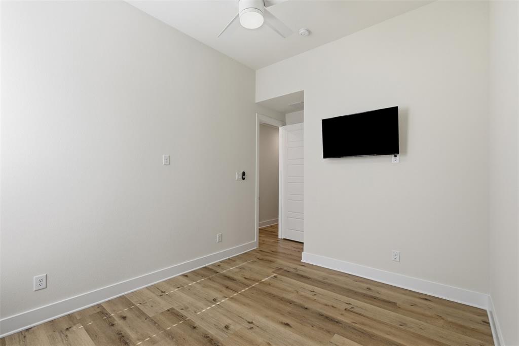 4400 Rocky Rdg Trail Little Elm, TX 75068 - Photo 25 of 40 a view of a livingroom with wooden floor and a flat screen tv