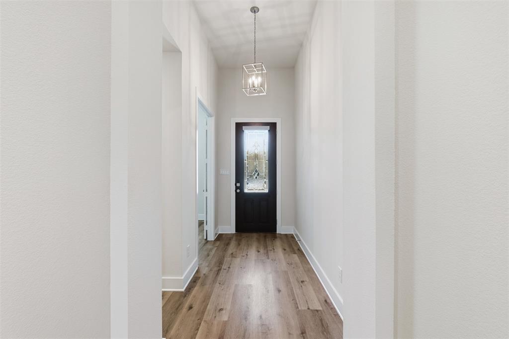 4400 Rocky Rdg Trail Little Elm, TX 75068 - Photo 6 of 40 Doorway with wood finished floors and a chandelier