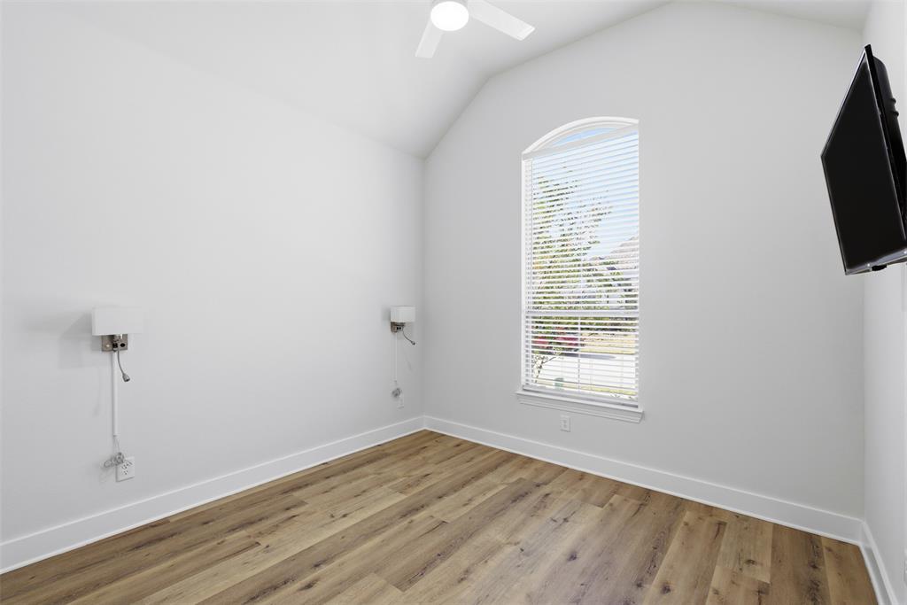 4400 Rocky Rdg Trail Little Elm, TX 75068 - Photo 9 of 40 an empty room with wooden floor and windows
