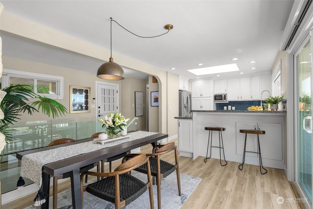 a dining room with furniture and wooden floor