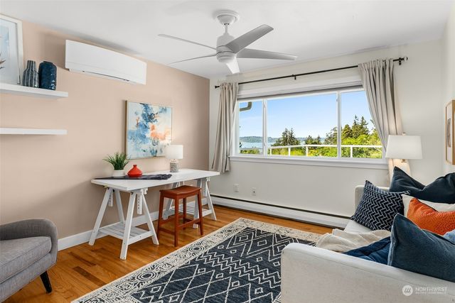 a bedroom with a bed couch and a large window