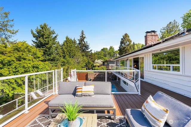 a roof deck with table and chairs