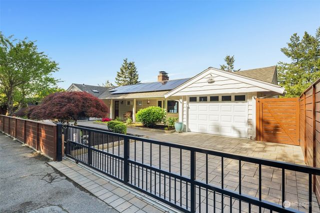 a view of a house with a yard and sitting area