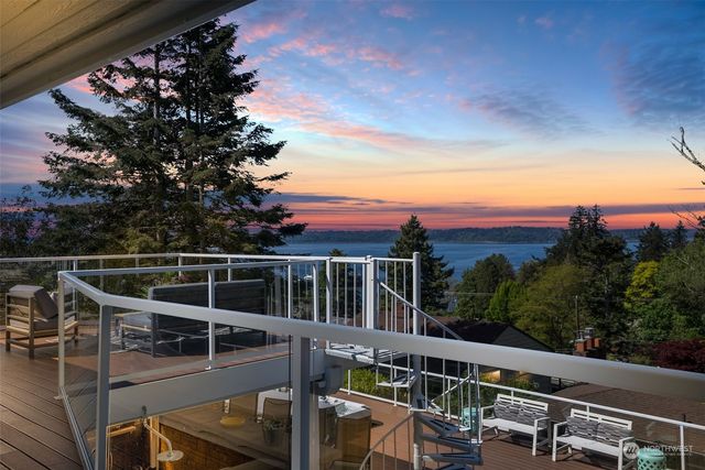a roof deck with couches and wooden floor