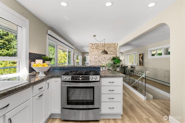 a dining room filled chandelier and wooden floor