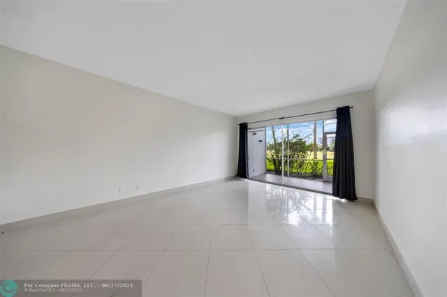 a view of an empty room with a sliding door