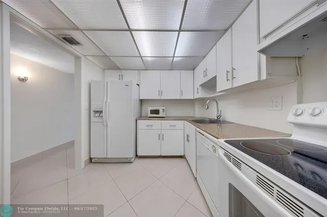 a kitchen with cabinets stainless steel appliances and counter space
