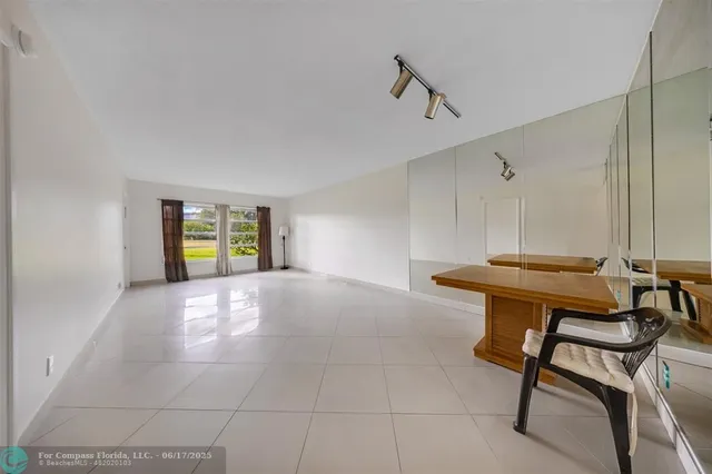 a view of an empty room with window and fireplace