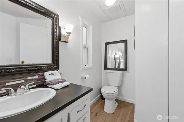 a bathroom with a toilet sink and mirror