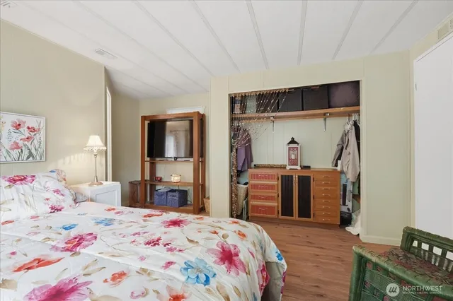 a bedroom with a bed and a dresser in it