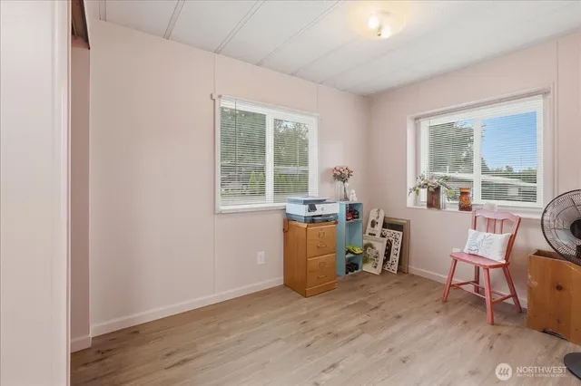 a view of a workspace with furniture and a window