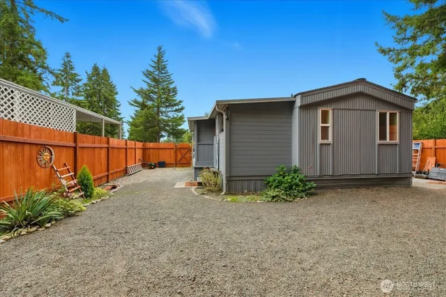 a backyard of a house with plants and trees