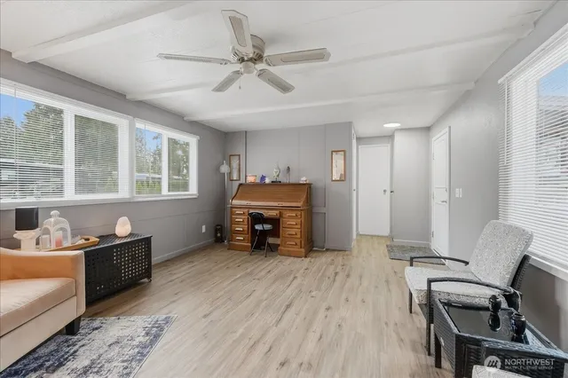 a view of a livingroom with furniture and a window