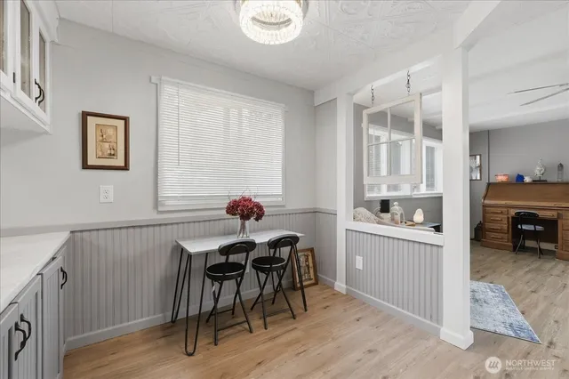 a workspace room with furniture and wooden floor