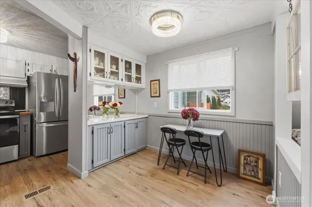 a kitchen that has a table and chairs in it