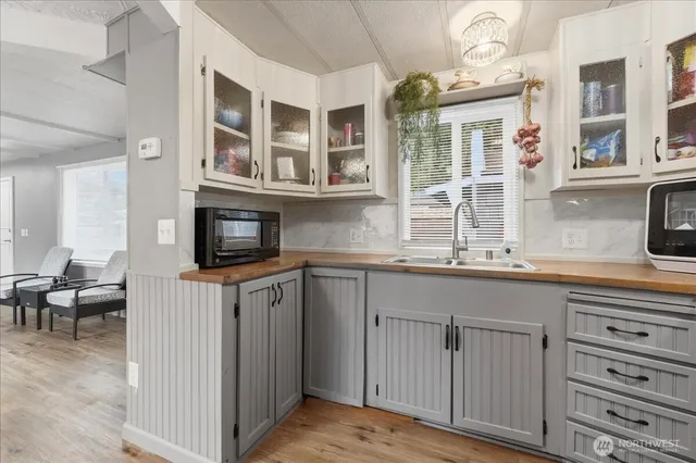 a kitchen with cabinets appliances and a window