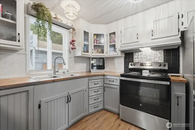 a kitchen with stainless steel appliances granite countertop a stove and a sink