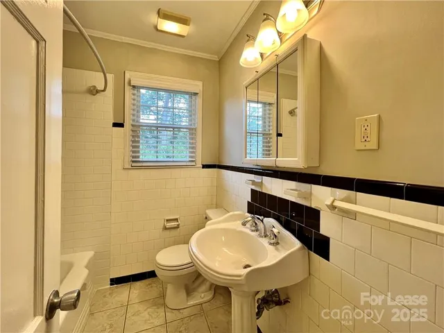 a bathroom with a sink mirror and toilet