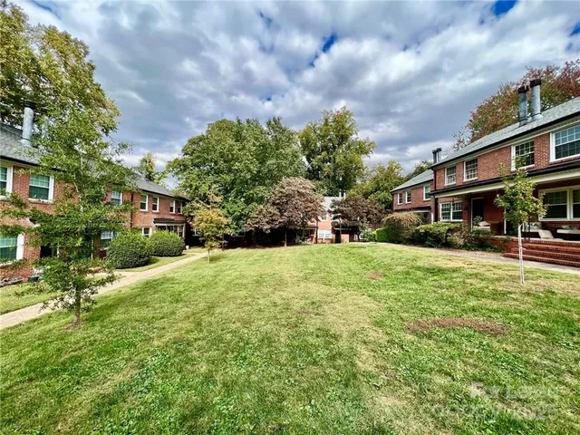 a front view of a building with a garden