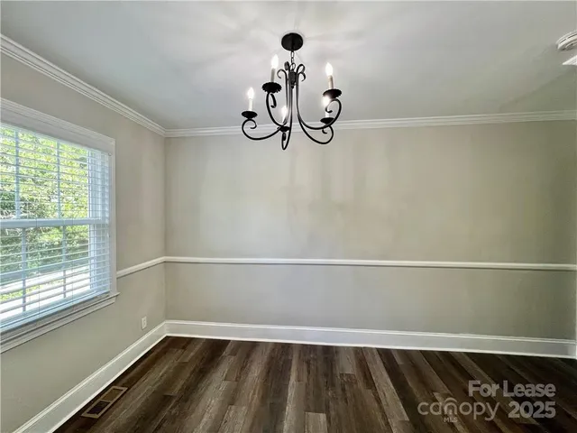 a view of a room with rack on the wall and a window