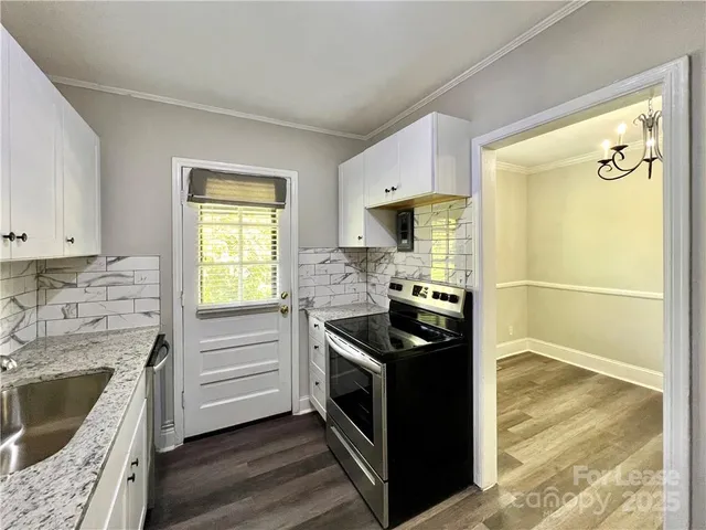 a kitchen with a stove a sink and a refrigerator