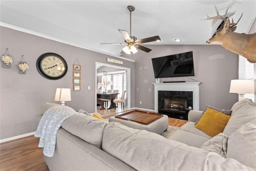 105 Chrissy Drive Temple, GA 30179 - Photo 12 of 47 a living room with furniture a flat screen tv and a fireplace