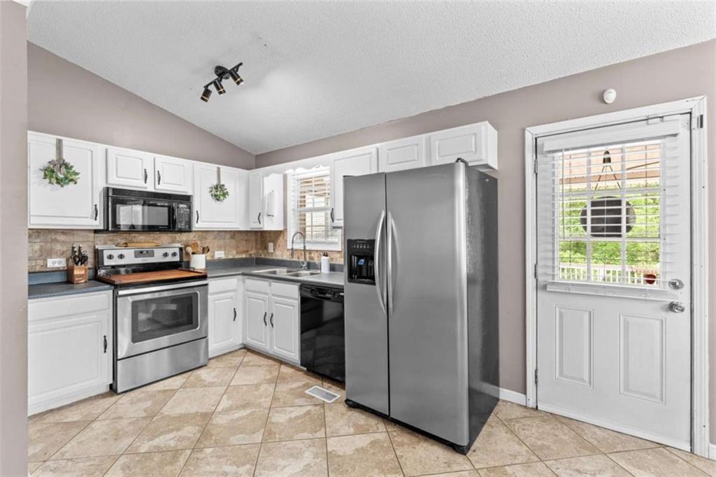 105 Chrissy Drive Temple, GA 30179 - Photo 17 of 47 a kitchen with stainless steel appliances granite countertop a refrigerator sink and stove