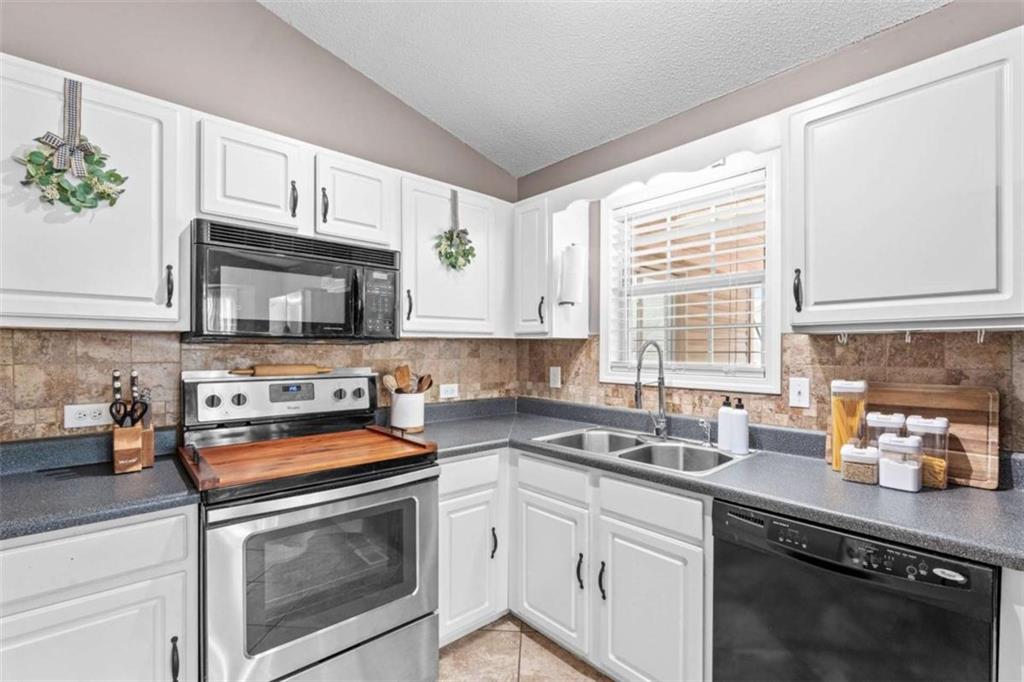 105 Chrissy Drive Temple, GA 30179 - Photo 19 of 47 a kitchen with stainless steel appliances granite countertop white cabinets sink stove and microwave