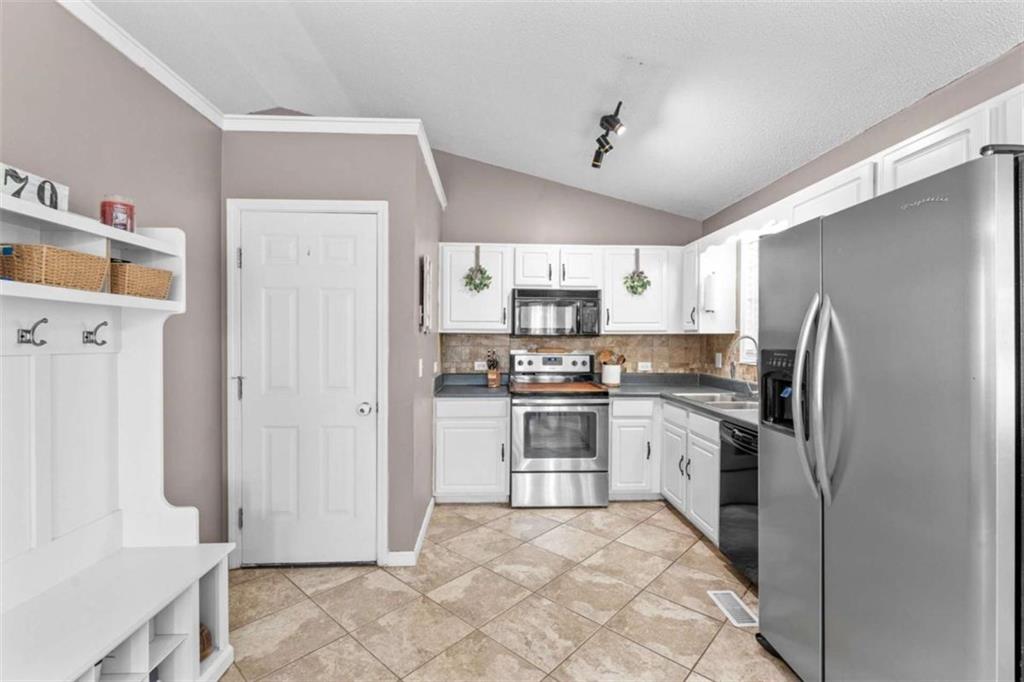 105 Chrissy Drive Temple, GA 30179 - Photo 20 of 47 a kitchen with stainless steel appliances granite countertop a refrigerator stove and sink
