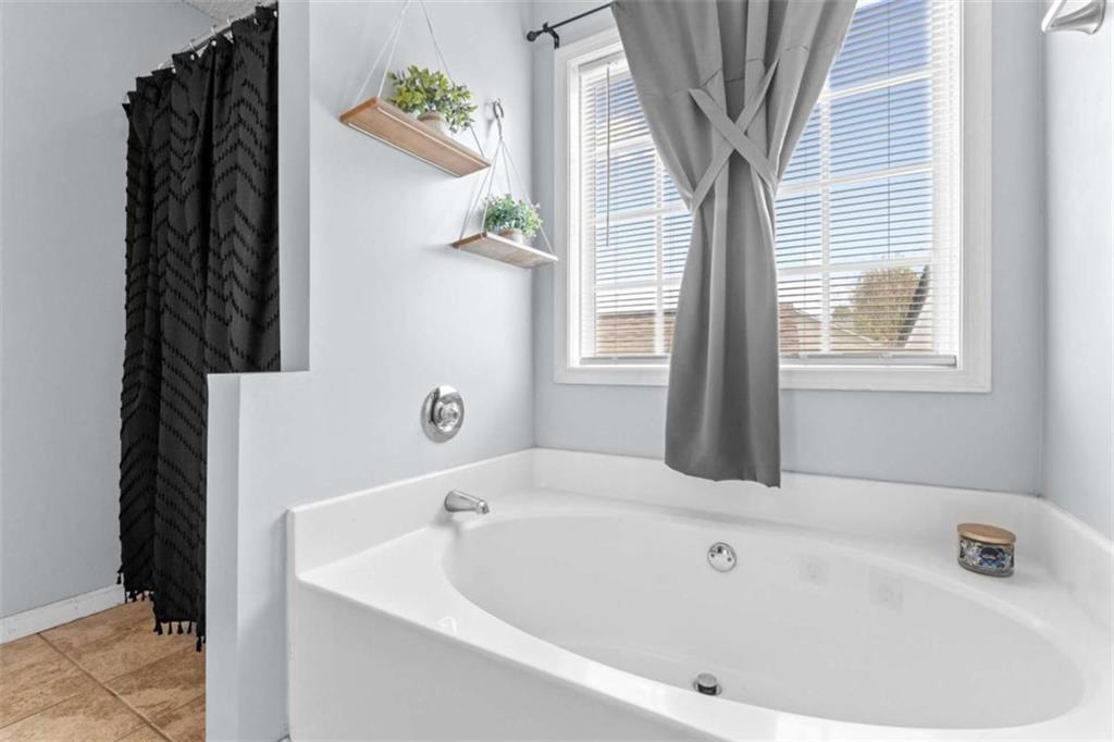 105 Chrissy Drive Temple, GA 30179 - Photo 25 of 47 a white bath tub sitting in a bathroom next to a window
