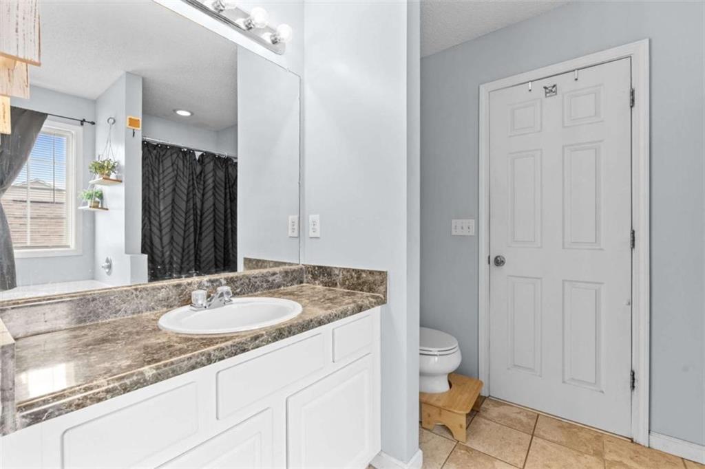 105 Chrissy Drive Temple, GA 30179 - Photo 26 of 47 a bathroom with a granite countertop sink a toilet and shower