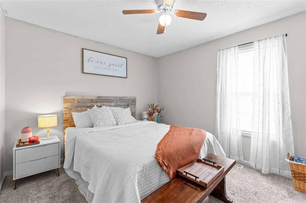 105 Chrissy Drive Temple, GA 30179 - Photo 28 of 47 a bedroom with a bed and a chandelier