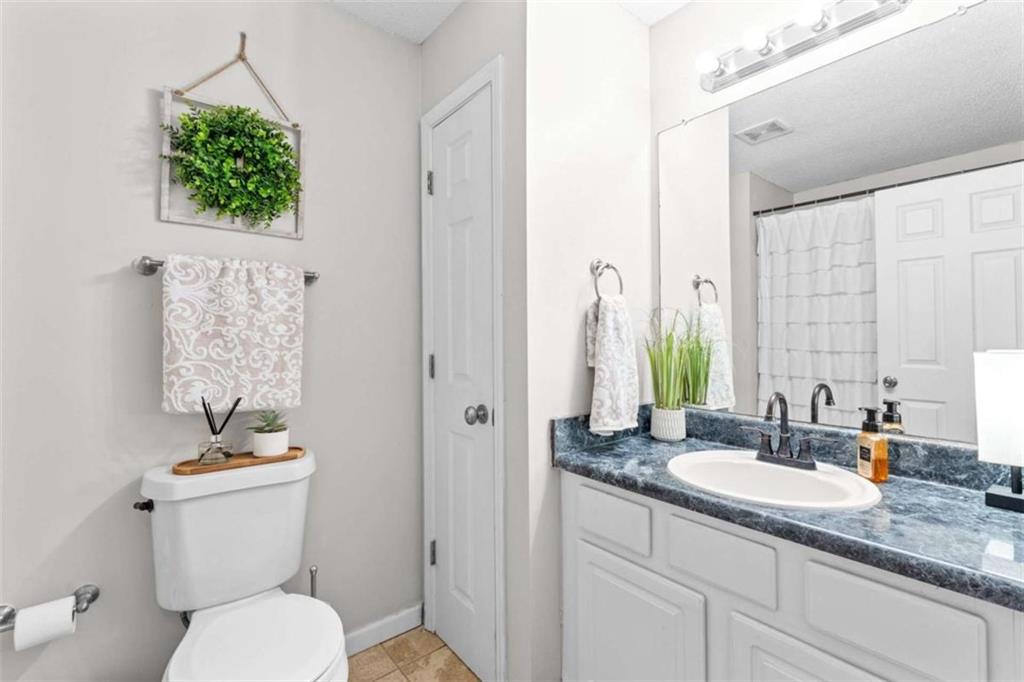 105 Chrissy Drive Temple, GA 30179 - Photo 29 of 47 a bathroom with a granite countertop sink a toilet a mirror and shower