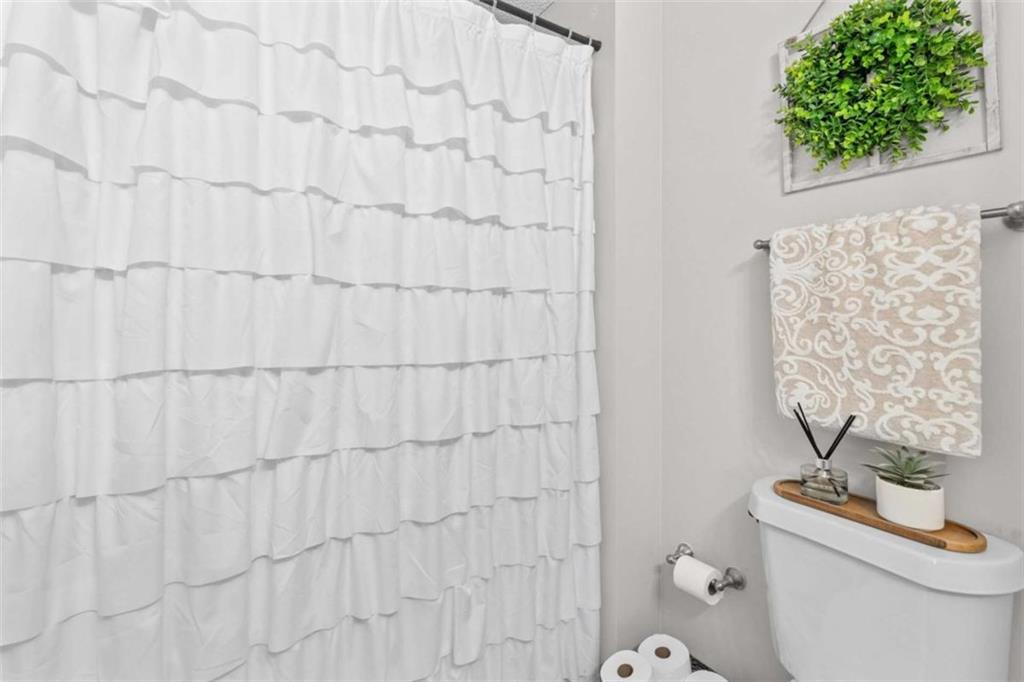 105 Chrissy Drive Temple, GA 30179 - Photo 30 of 47 a bathroom with a toilet and a shower curtain