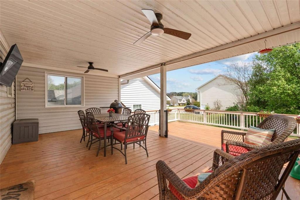 105 Chrissy Drive Temple, GA 30179 - Photo 40 of 47 a view of a roof deck with table and chairs and wooden floor