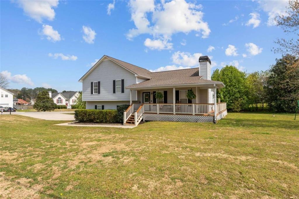 105 Chrissy Drive Temple, GA 30179 - Photo 5 of 47 a view of a house with a swimming pool and a tree
