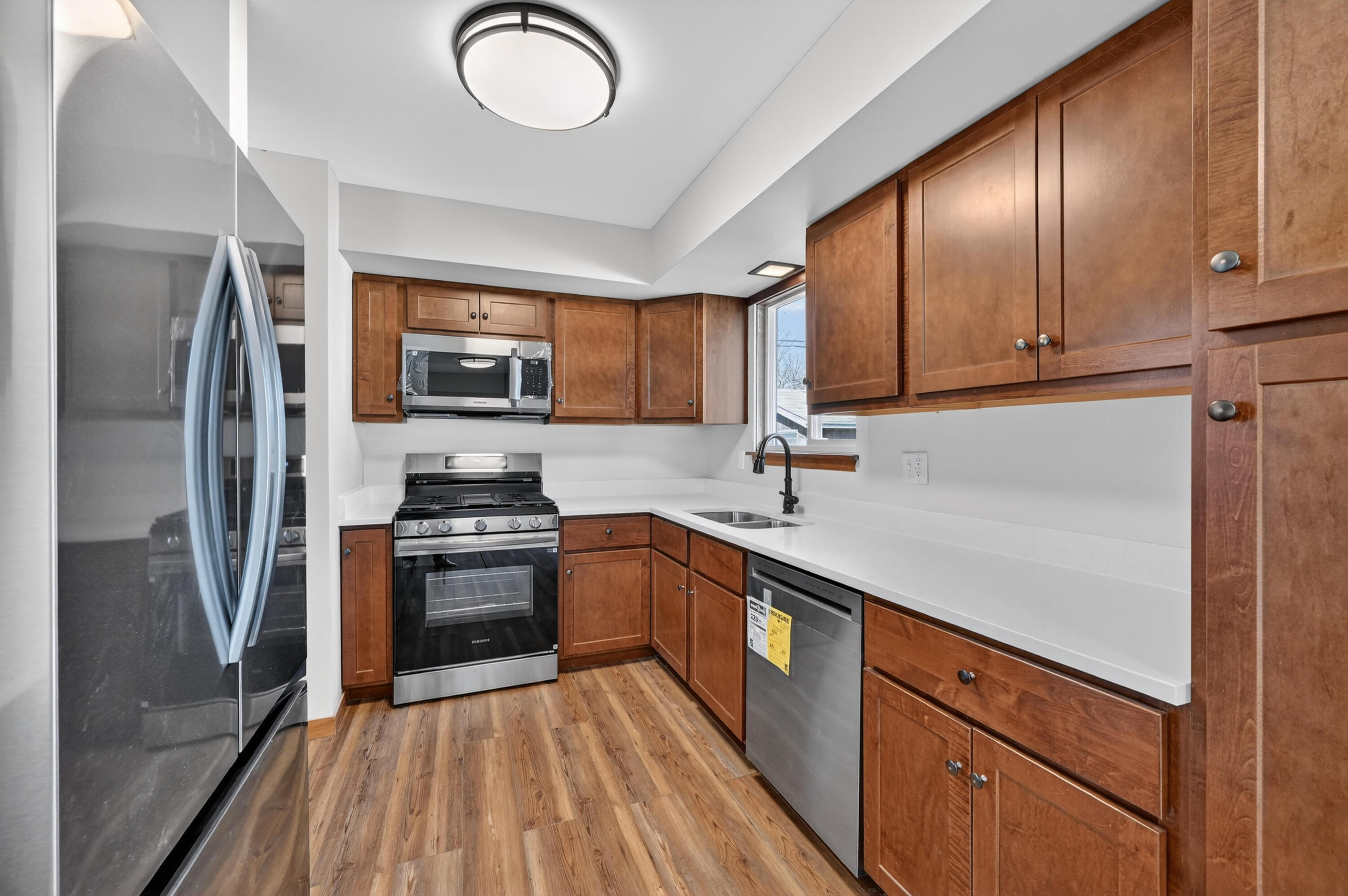 1006 West Ash Street Griffith, IN 46319 - Photo 12 of 25 a kitchen with stainless steel appliances granite countertop a refrigerator sink and stove
