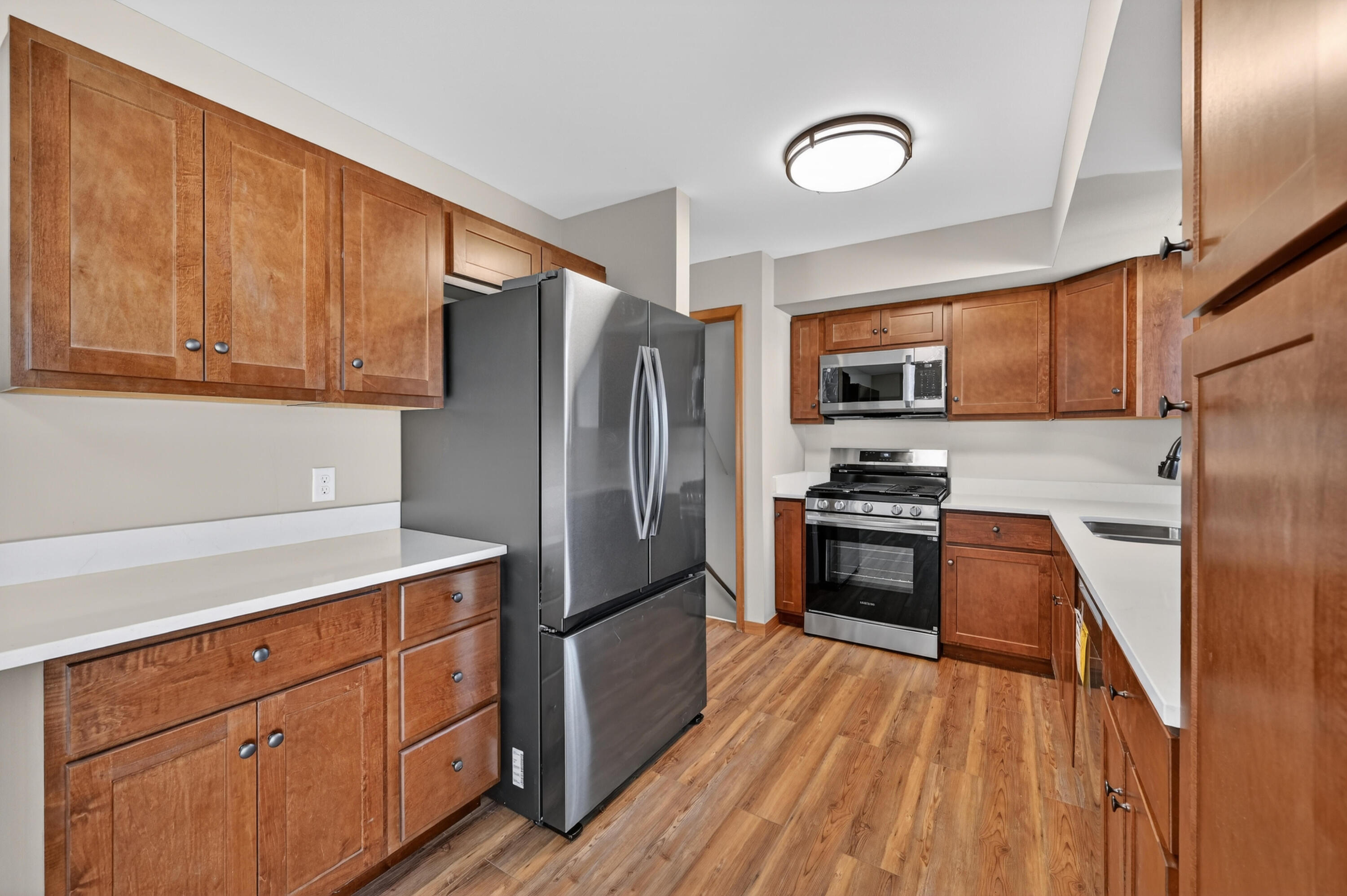 1006 West Ash Street Griffith, IN 46319 - Photo 13 of 25 a kitchen with granite countertop stainless steel appliances and wooden cabinets