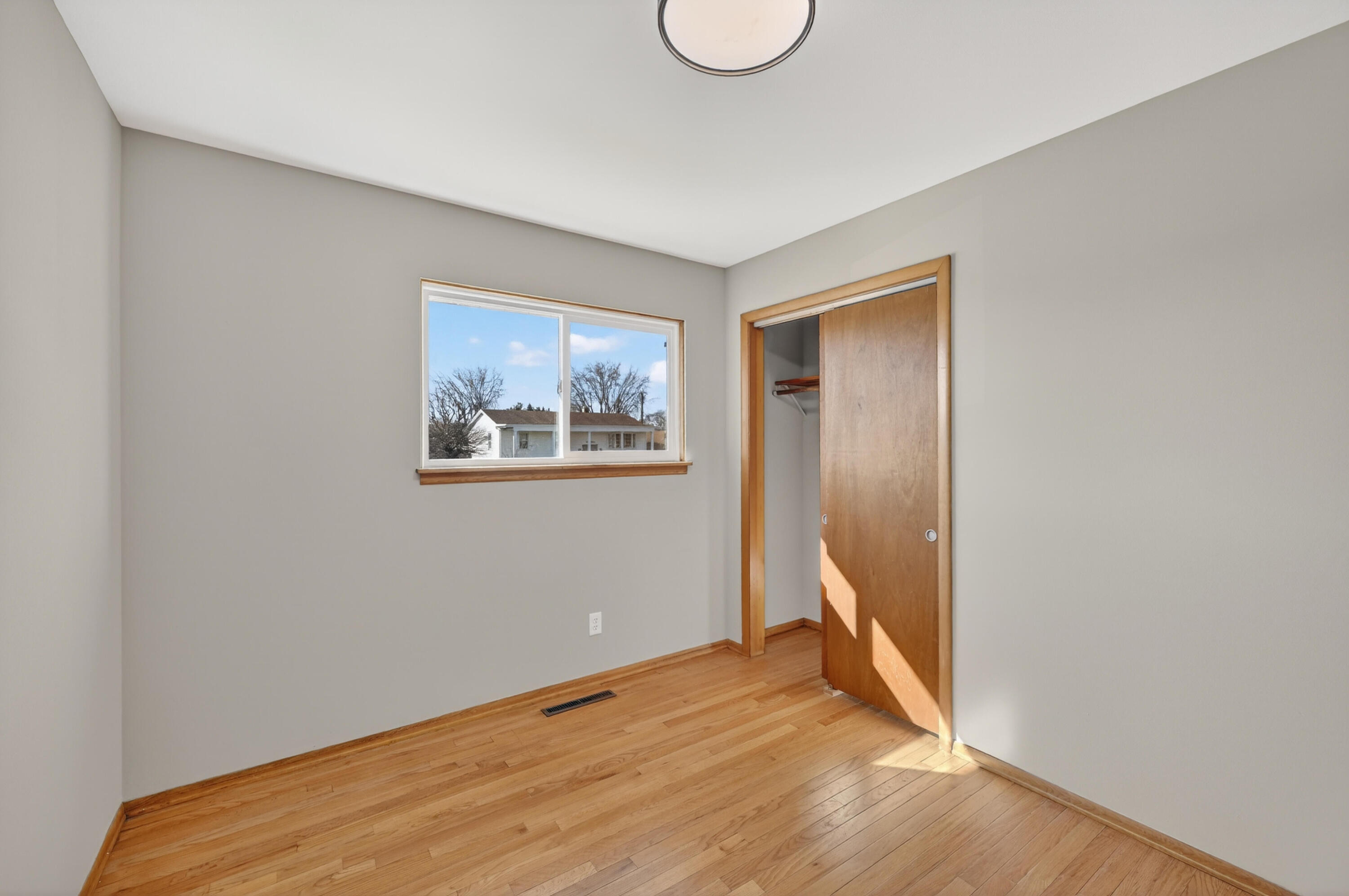 1006 West Ash Street Griffith, IN 46319 - Photo 15 of 25 a view of an empty room with wooden floor and a window