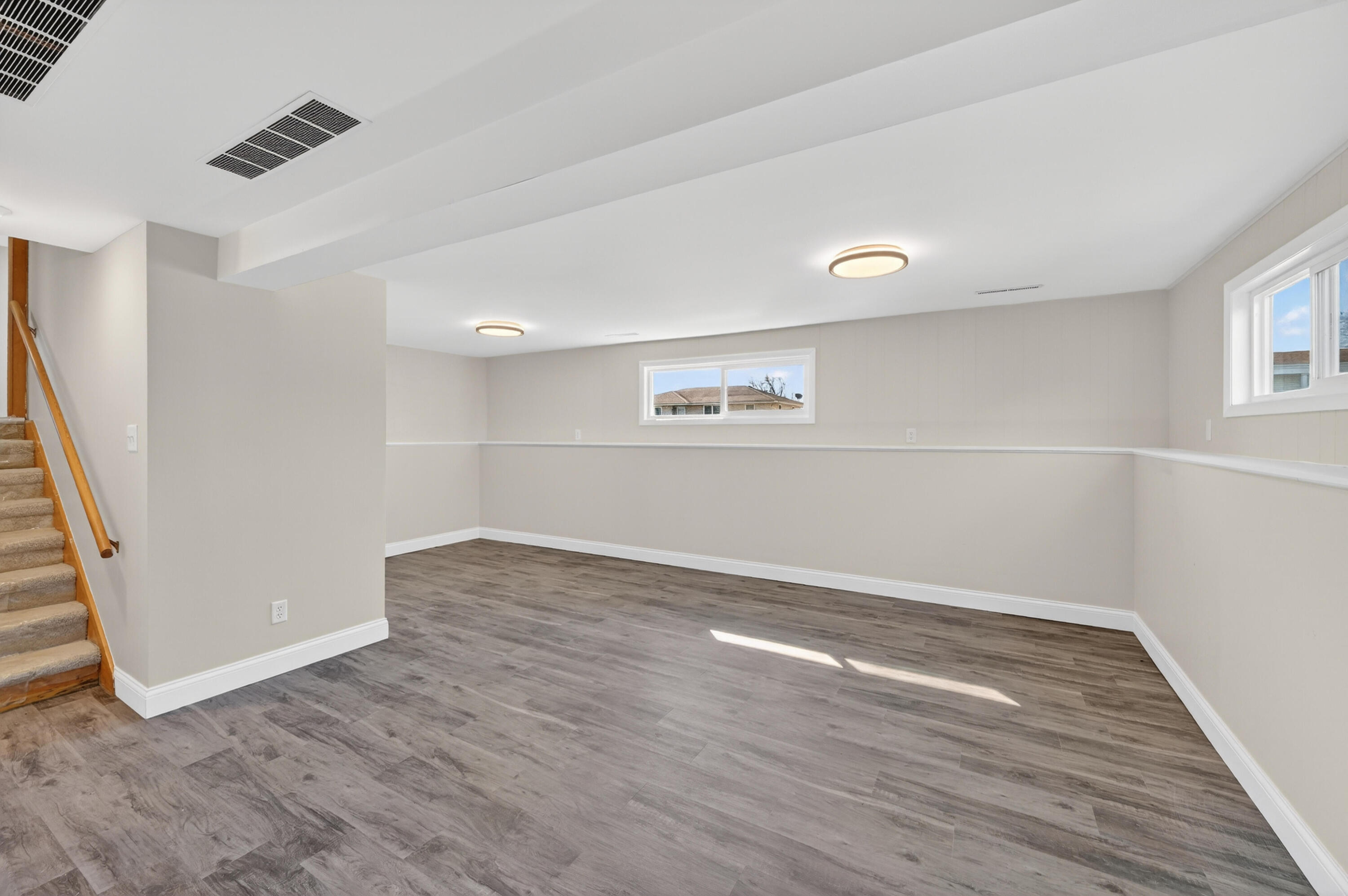 1006 West Ash Street Griffith, IN 46319 - Photo 21 of 25 an empty room with wooden floor and windows
