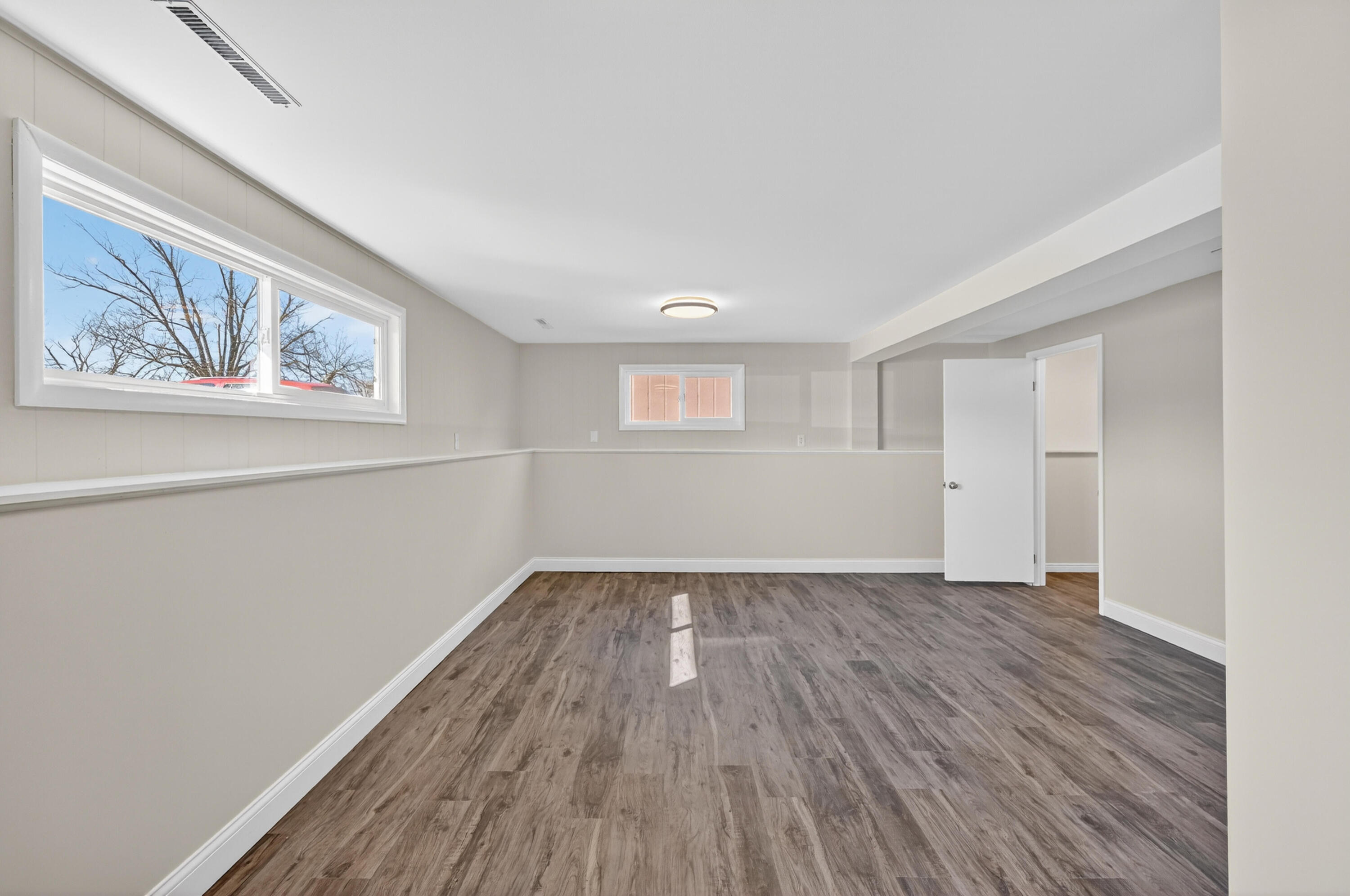 1006 West Ash Street Griffith, IN 46319 - Photo 22 of 25 a view of an empty room with wooden floor and a window