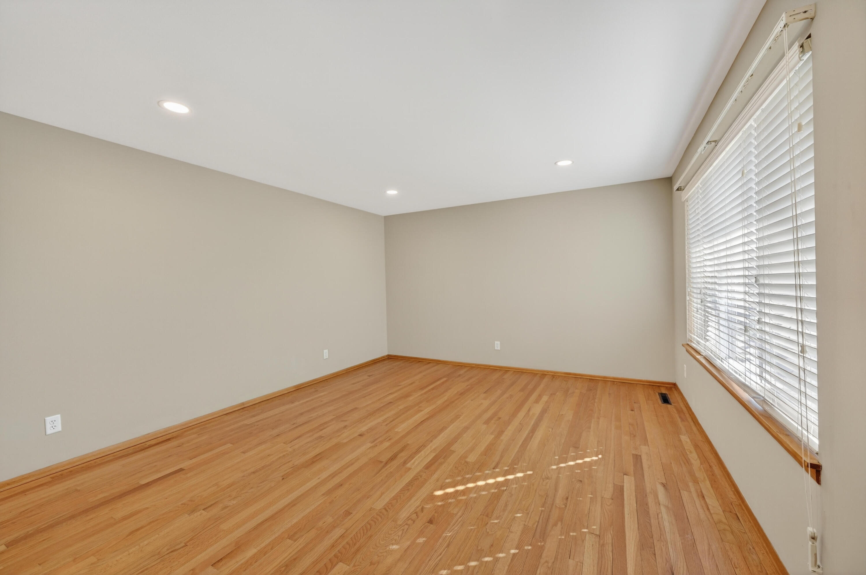1006 West Ash Street Griffith, IN 46319 - Photo 5 of 25 a view of an empty room with wooden floor and a window