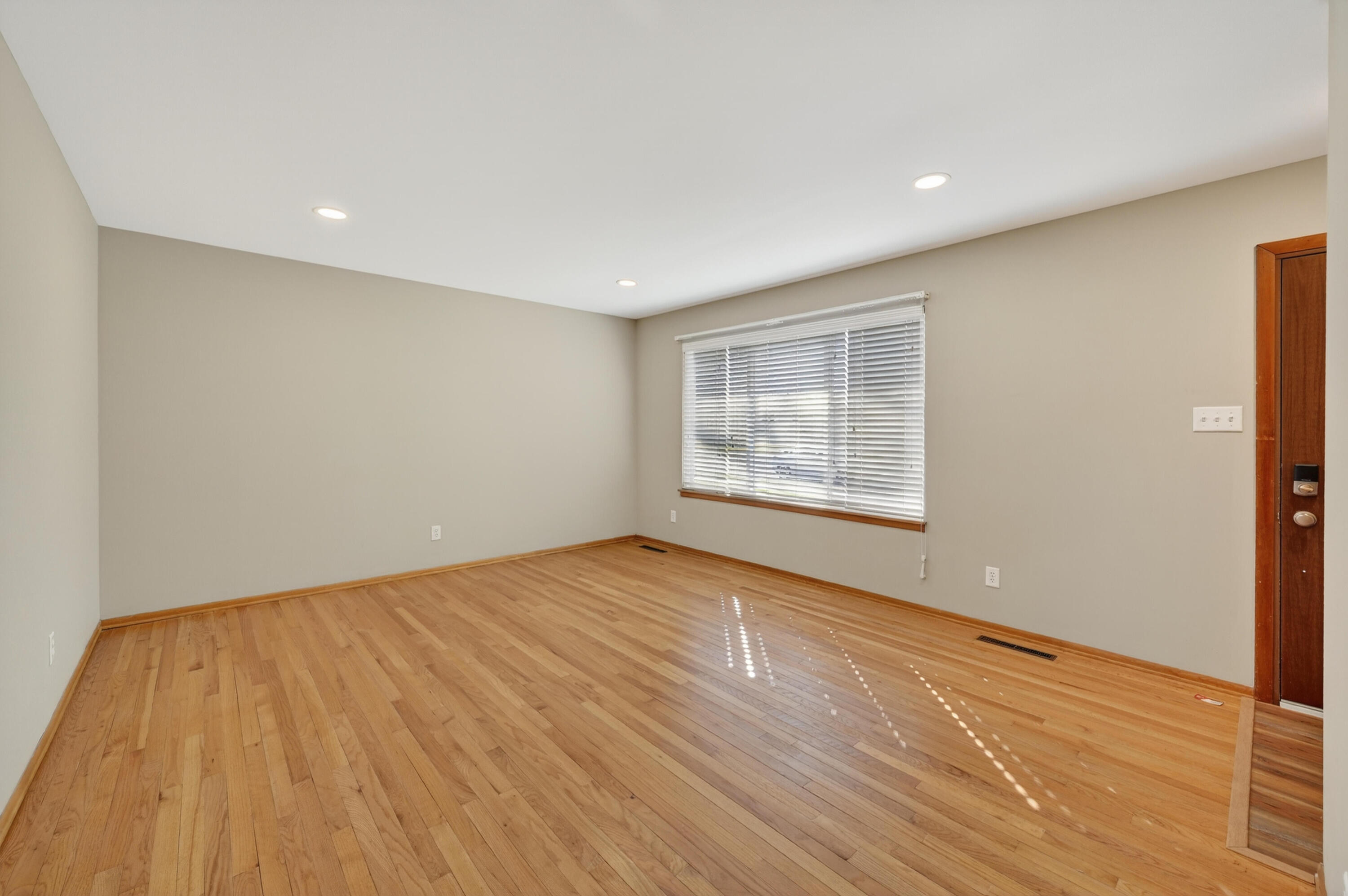 1006 West Ash Street Griffith, IN 46319 - Photo 6 of 25 a view of an empty room with wooden floor and a window