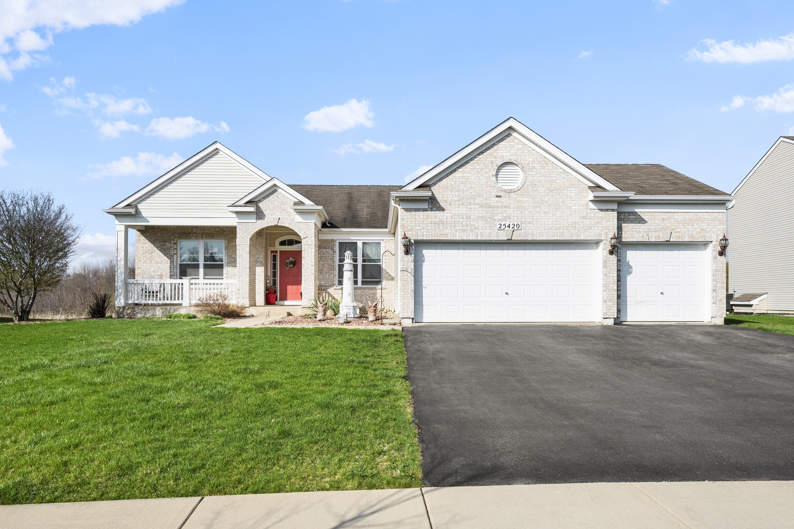 25420 Spring Street Manhattan, IL 60442 - Photo 1 of 27 a front view of a house with a yard and garage
