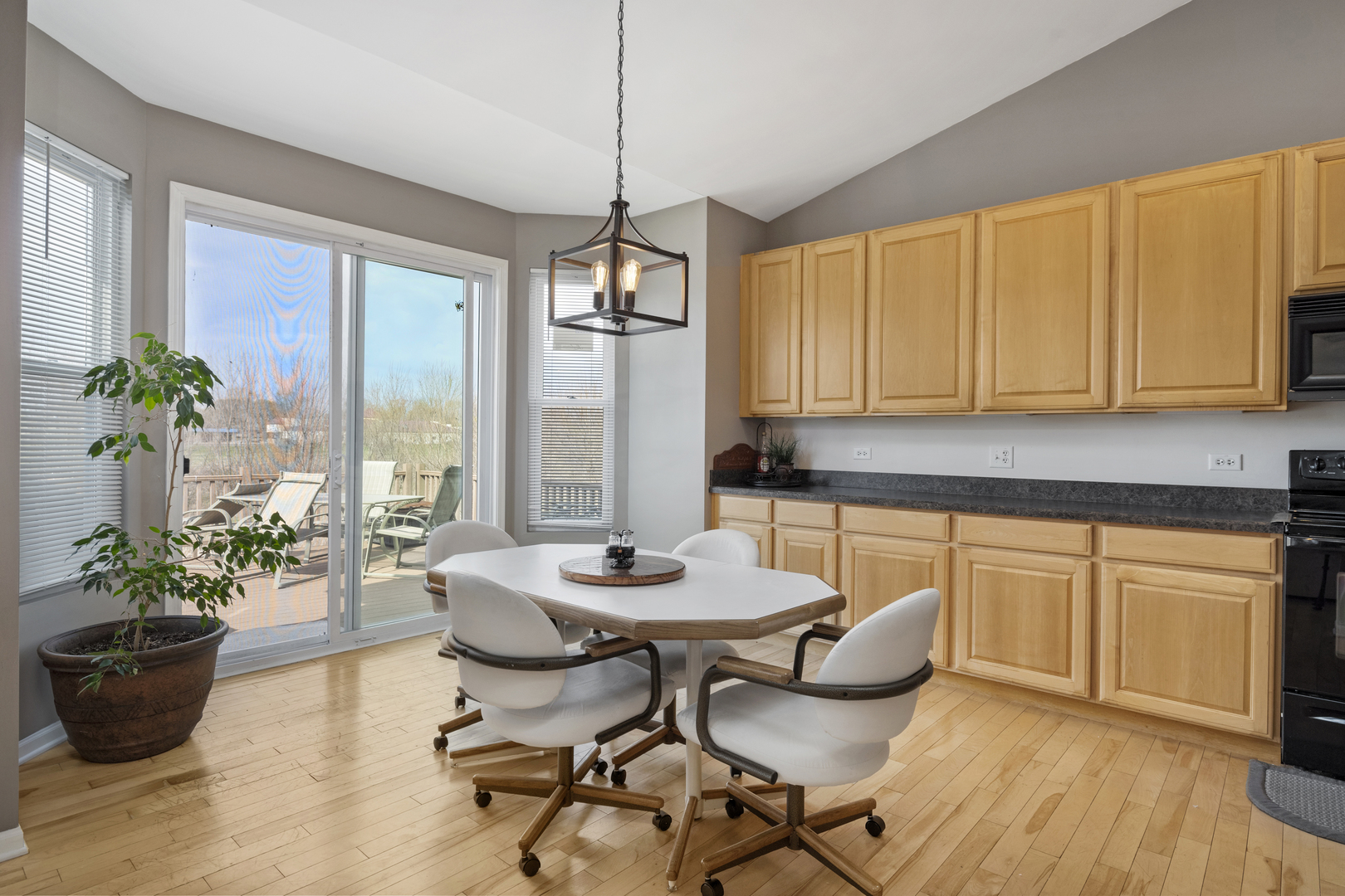 25420 Spring Street Manhattan, IL 60442 - Photo 13 of 27 a view of a dining room with furniture window and wooden floor